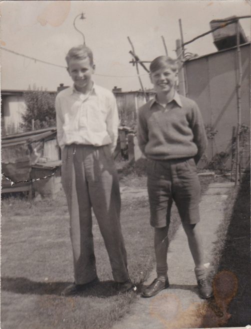 Brian and Barry Clare standing in the garden of the prefab | Hearn,Jane