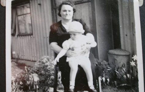 Woman with baby in front of Arcon prefab