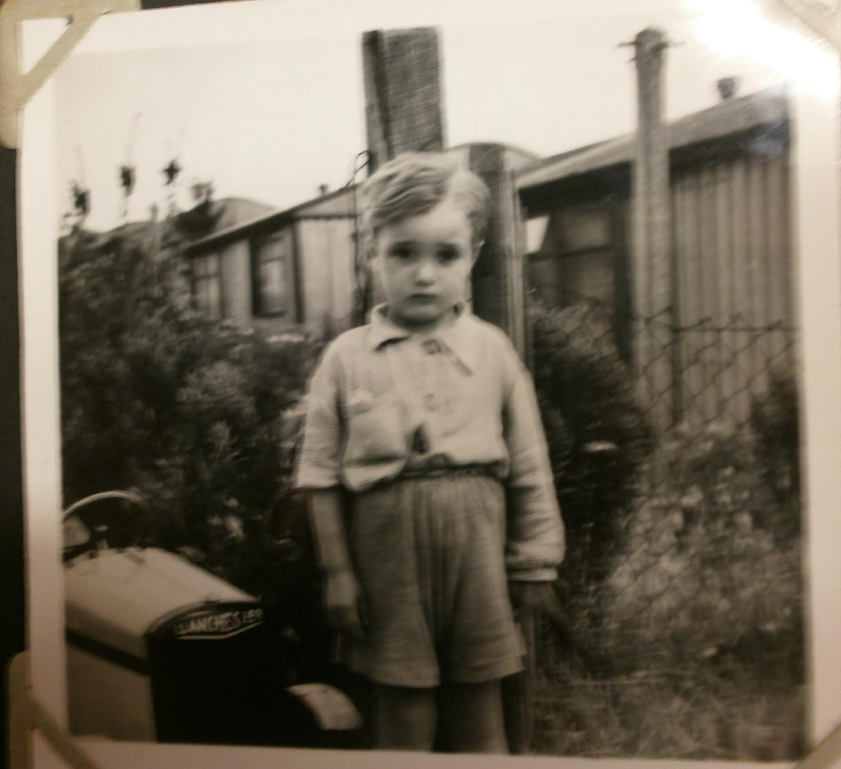 Small boy with toy car in front of Arcon prefab