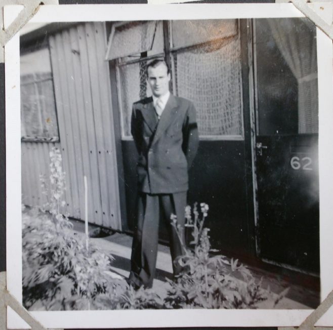 Man in front of Arcon prefab | Hearn,Jane