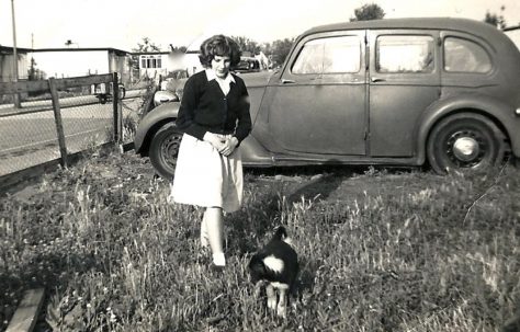 Rosemary Brine in the prefab garden with dog and car in the background