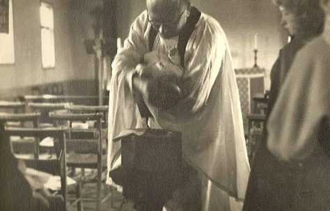 A Brine family baby being baptised at St Mark's Church, nicknamed "The Prefab Church"