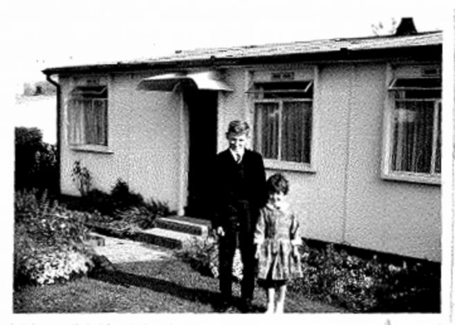 Photo of Allen and Judith Sawkins' family prefab (AIROH) in Farnham, Surrey, 50s, with brother and sister Allen and Judith in front of prefab | Blanchet,Elisabeth