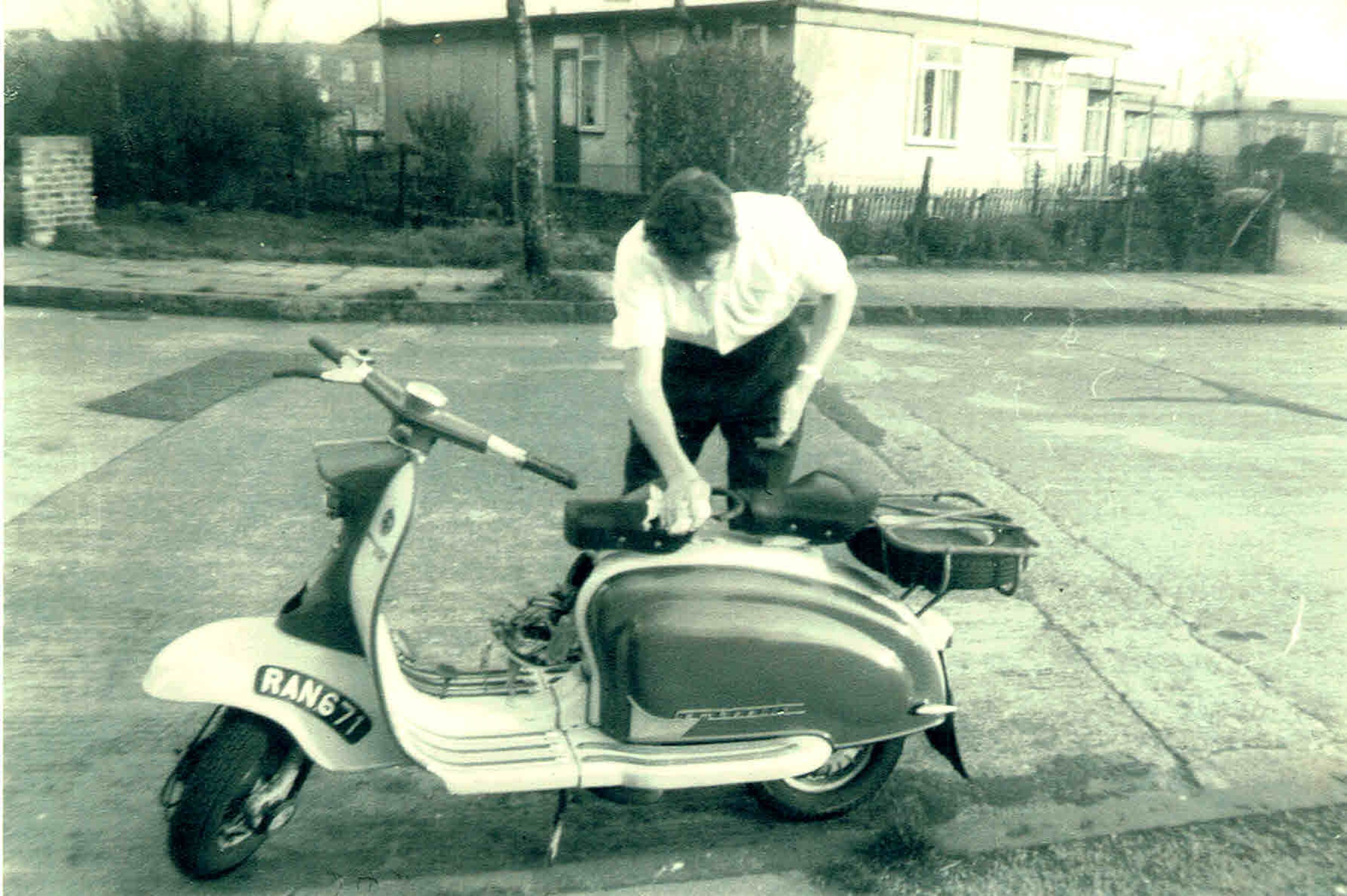 Bob Strudwick working on his scooter, taken from Mr and Mrs Marshalls prefab at No 6, Strattondale Street, Isle of Dogs, London 50s or 60s