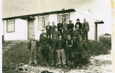 John Mason with other men in front of an AIROH Prefab  on the Wilson Avenue site, Whitehawk, Brighton in 1946.