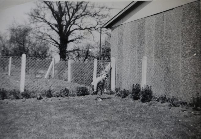 One of the Kapitan children playing in the prefab garden | Hearn,Jane