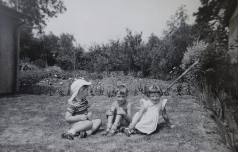 Three small children in the Kapitan prefab garden in Ipswich