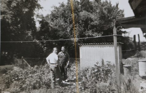 Mr Kapitan and friend in his prefab garden