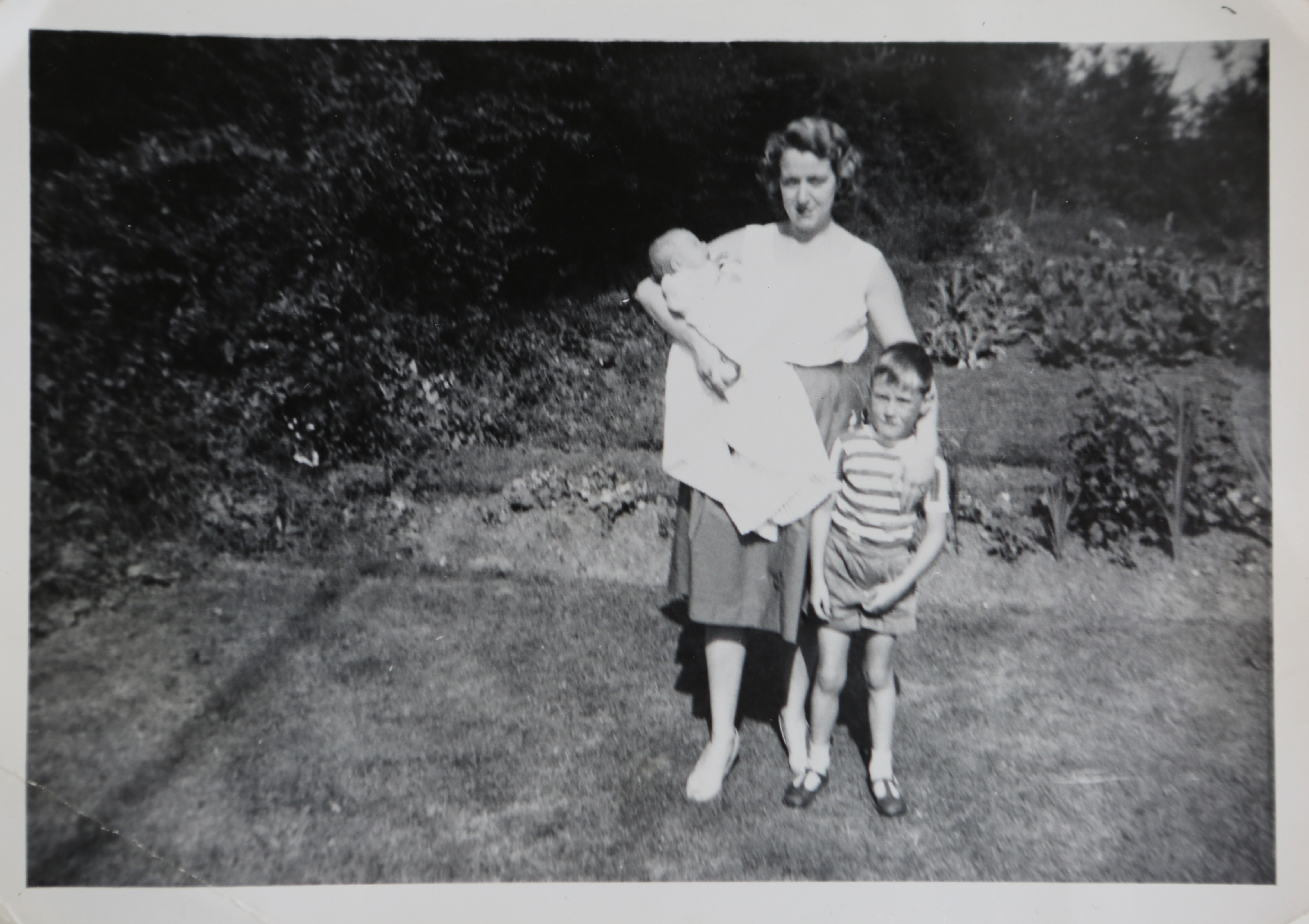 June Kapitan and her two children outside their prefab in Ipswich