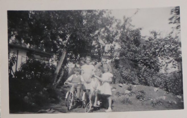 Four children, an adult and two bikes on the prefab estate at Willesden | Hearn, Jane