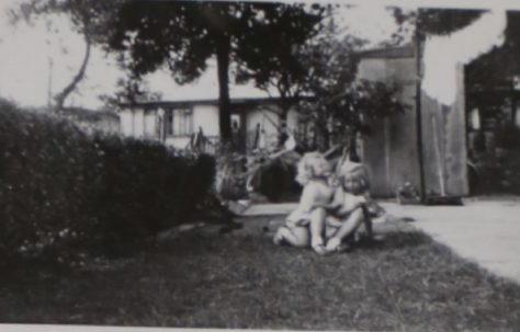 Two small children in the prefab garden in Willesden