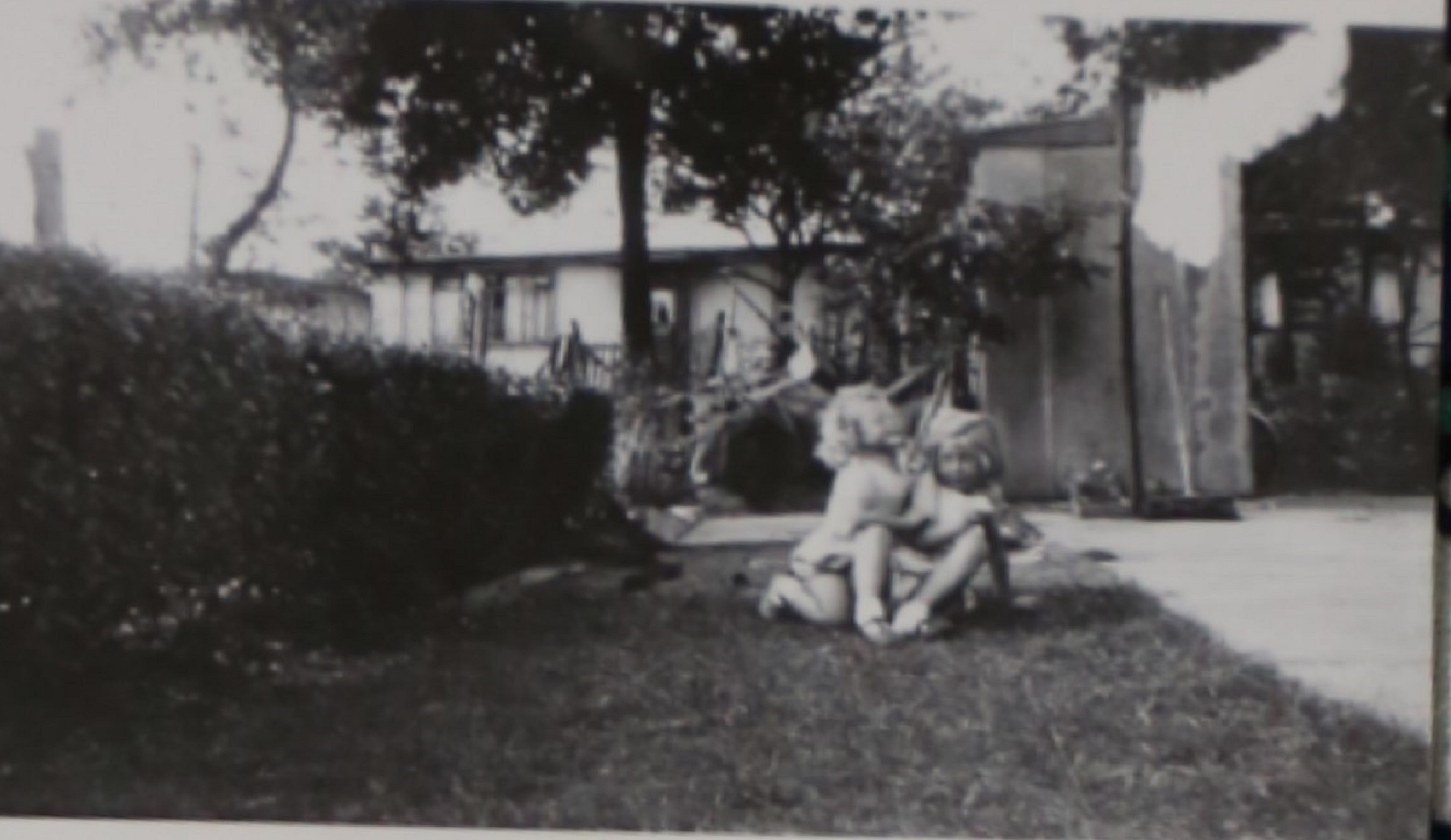 Two small children in the prefab garden in Willesden