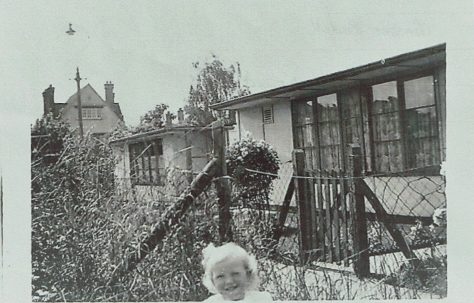 Small child in prefab garden in Willesden