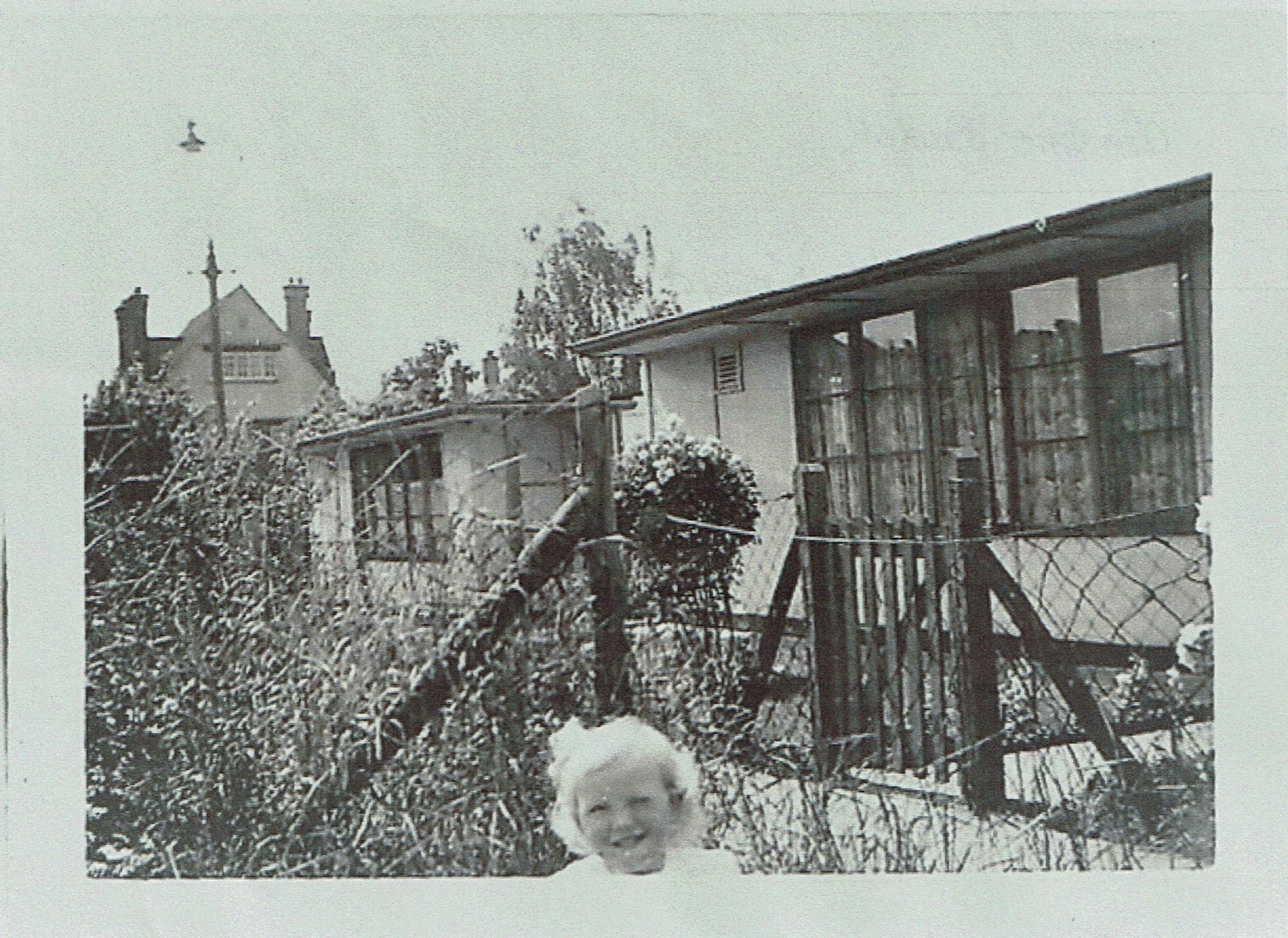 Small child in prefab garden in Willesden