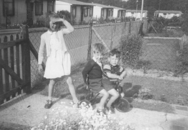 Three children, two on a bicycle, Shrublands Estate, New Addington