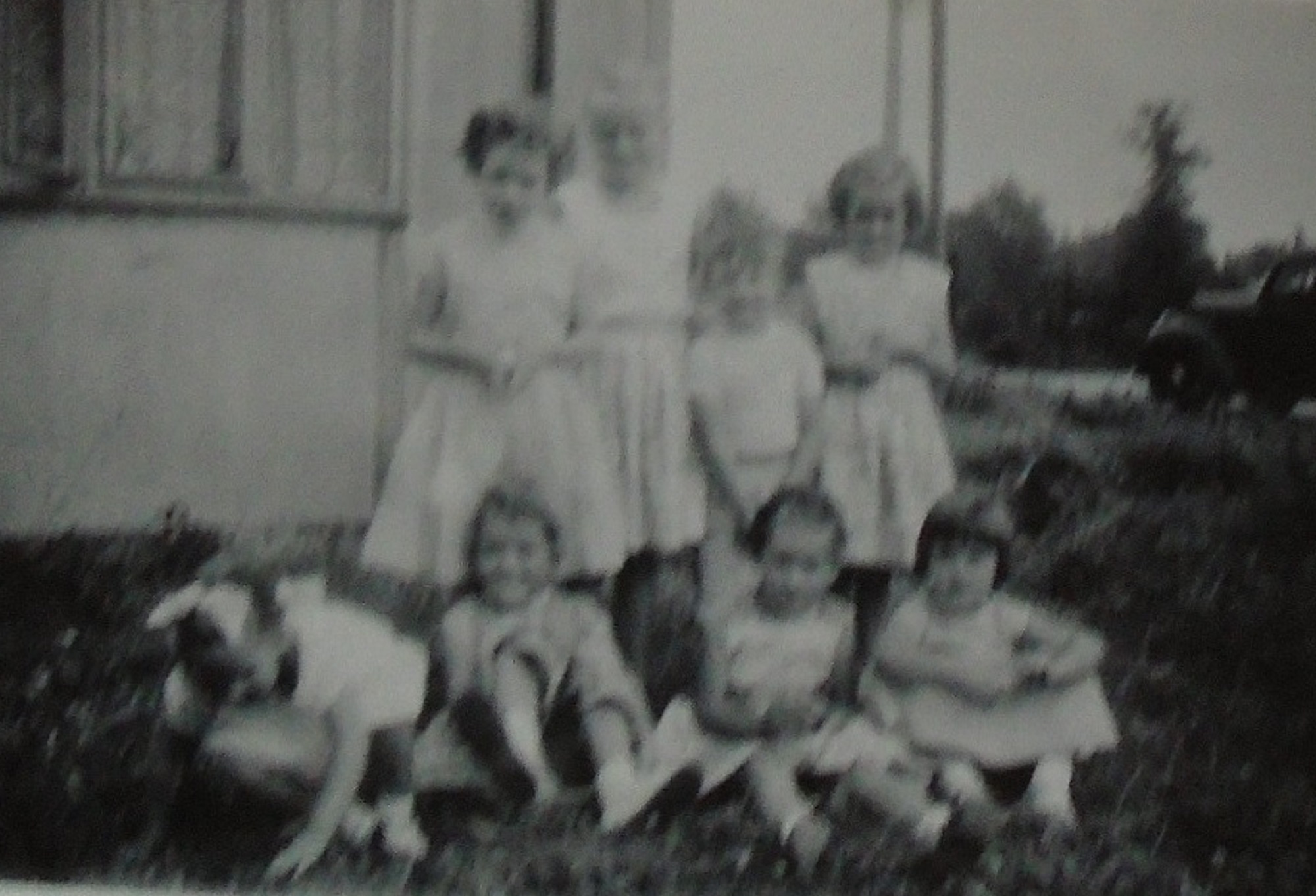 Group of eight children in front of Uni-Seco prefab, Silver End