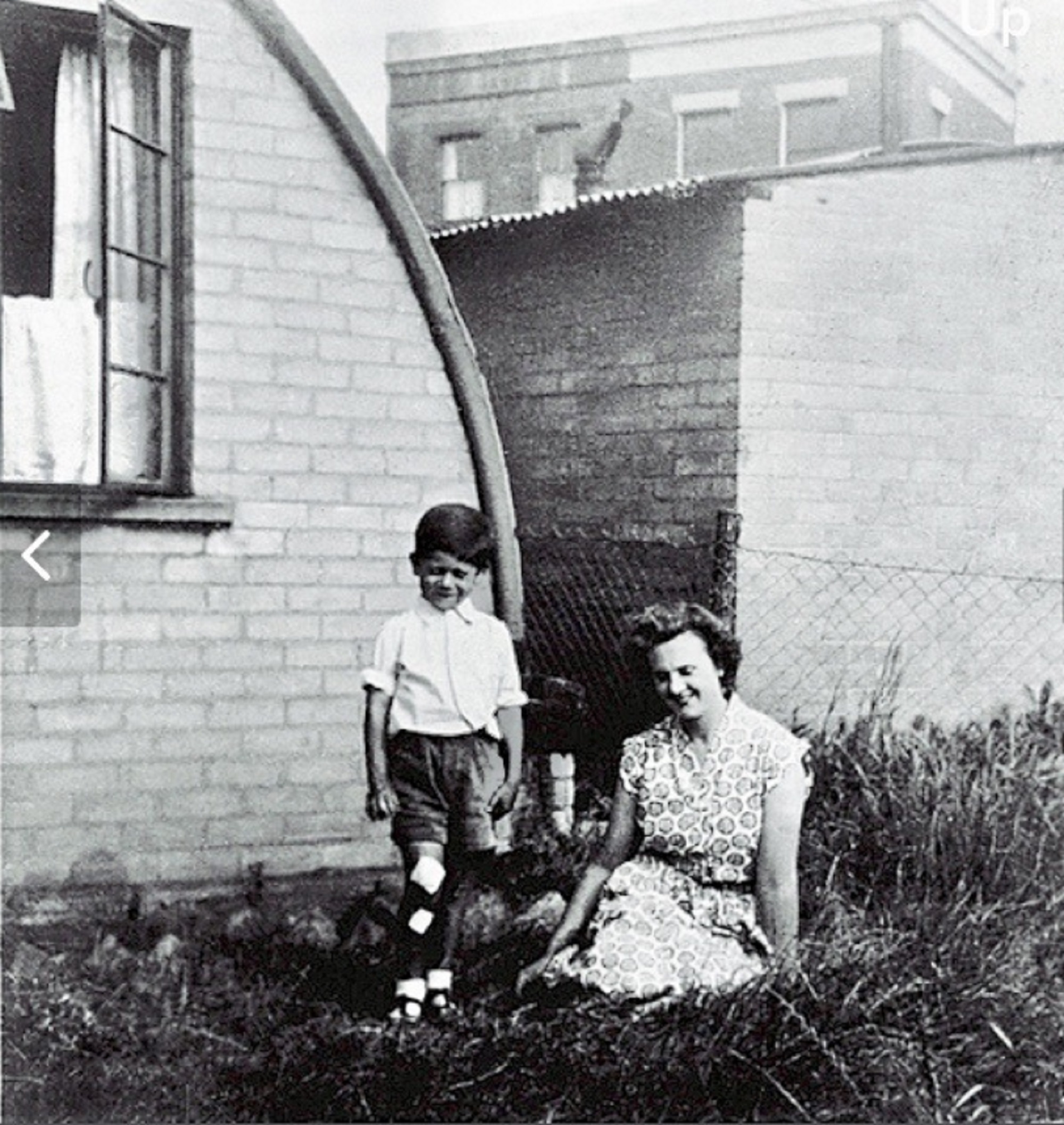 Peter and his mother in front of their Nissen Hut in Bentham Road, London E9