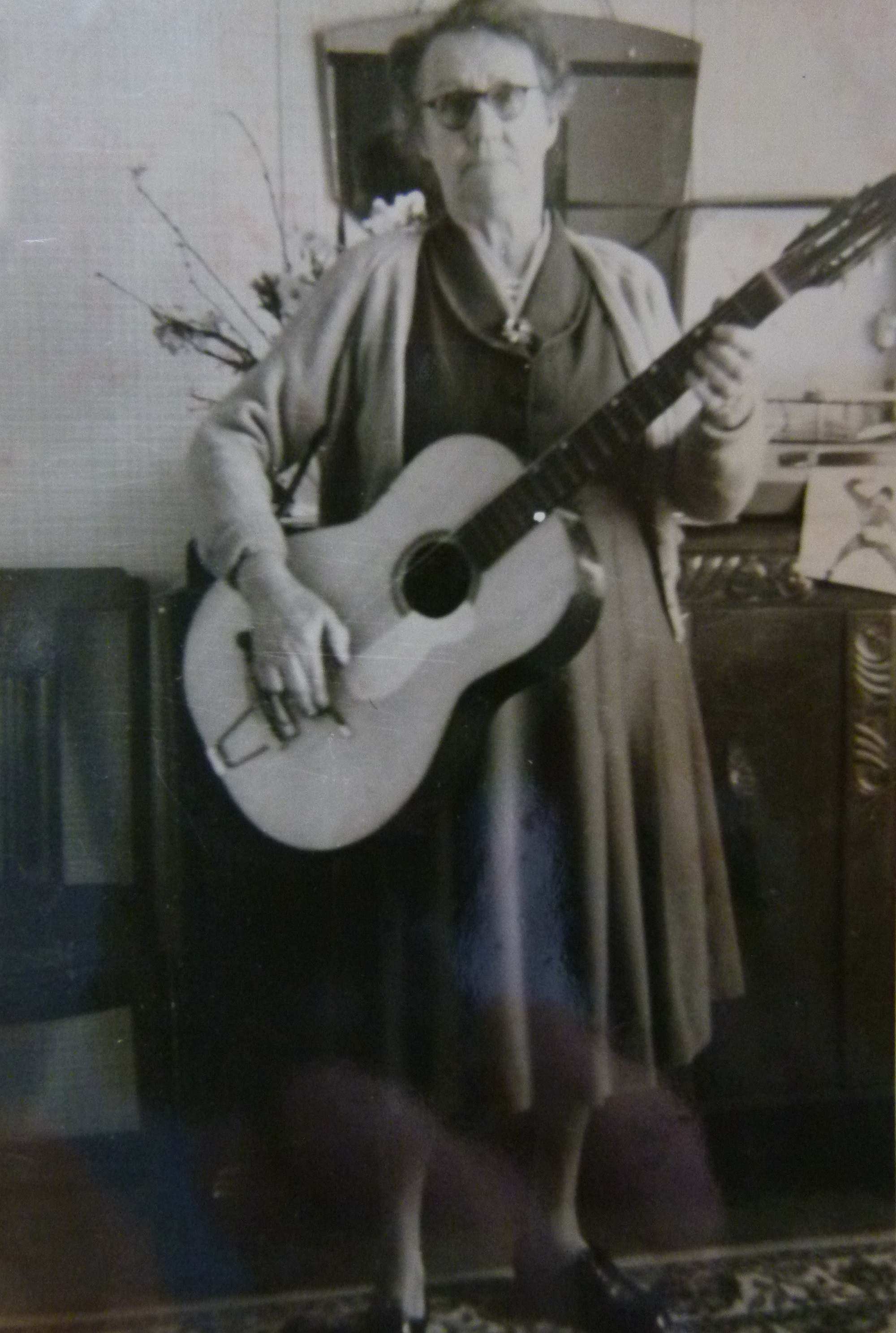 Grandma playing guitar in prefab, 401 Wake Green Road, Moseley