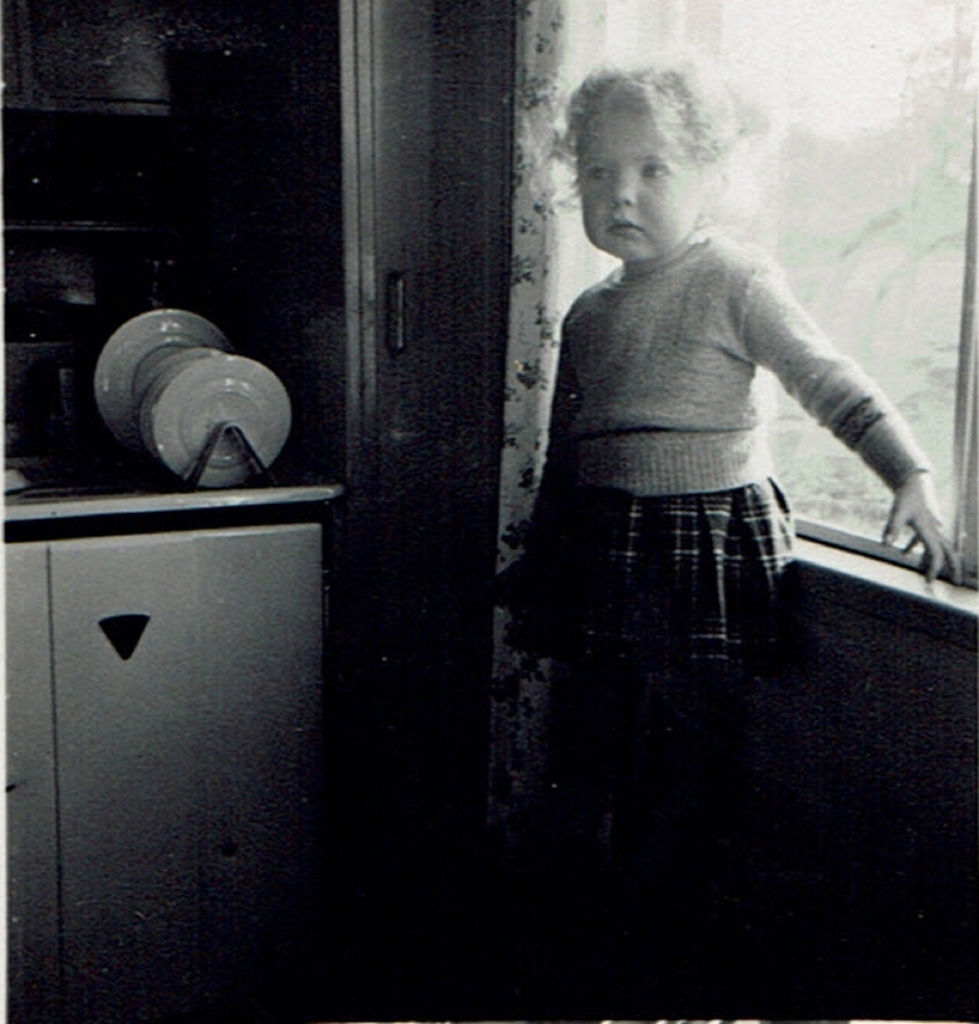 Suzanne aged two and a half years in the family prefab at Brake Road, Crown Hill