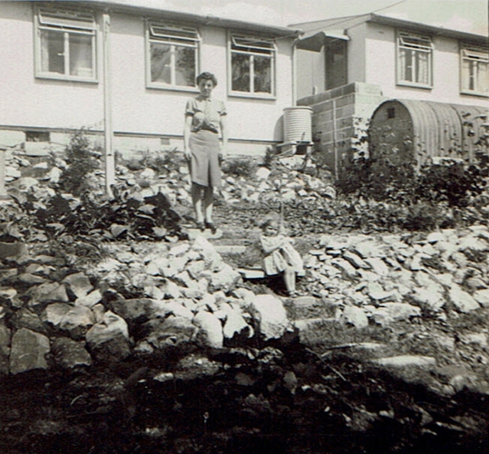 Suzanne and her mother in the back garden of their prefab at Brake Road, Crown Hill