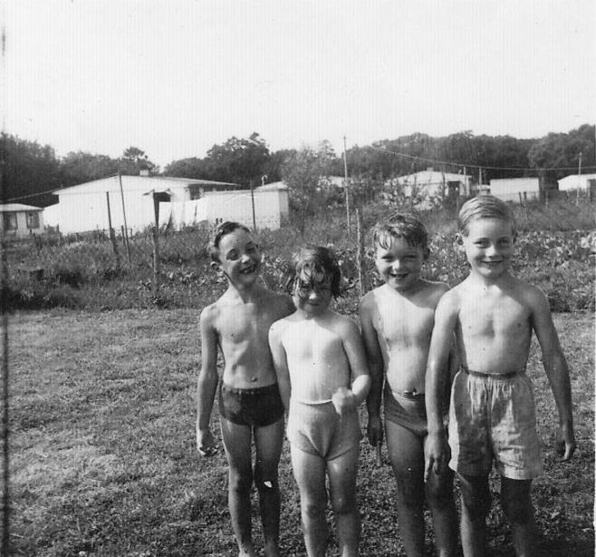 Four boys in swimming gear in the garden of a prefab at Gatwick Green, Bishops Stortford
