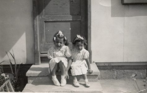 Two little girls sitting on a prefab step on the Harold Hill estate