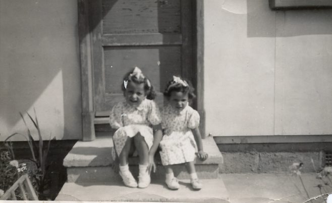 Two little girls sitting on a prefab step on the Harold Hill estate