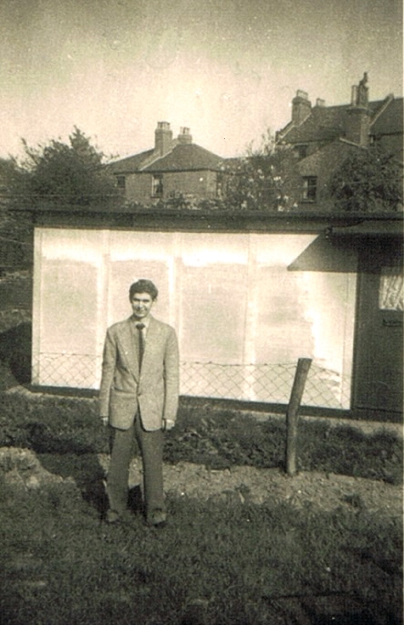 Brother Len in garden of 74 Narford Road. Next door's prefab can be seen