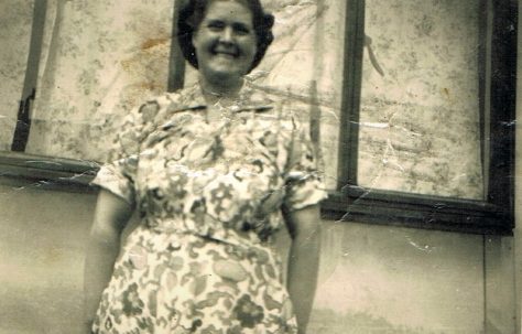 Mum outside the prefab looking happy. Narford Road, London E5