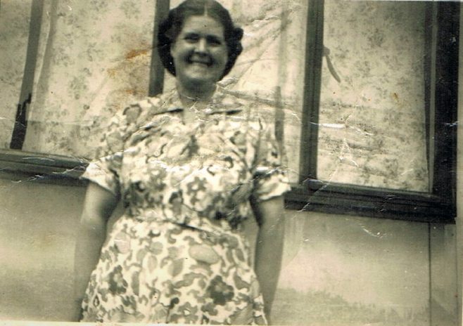 Mum outside the prefab looking happy. Narford Road, London E5