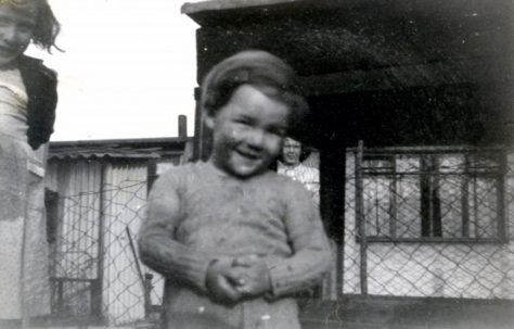 Two children, a girl and boy, outside a prefab in Underhill Road, London SE22