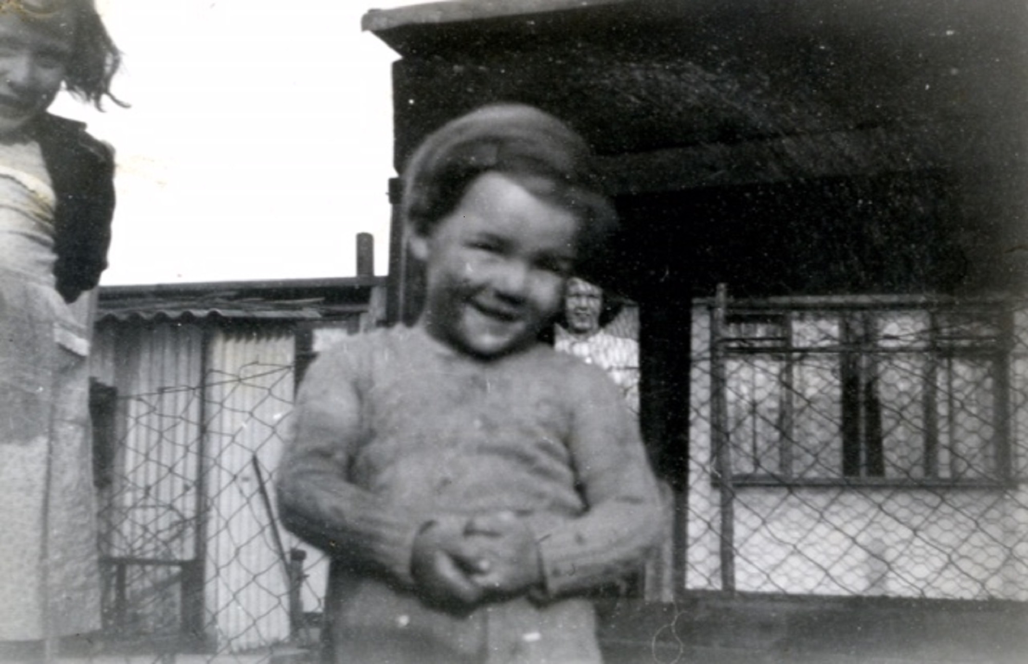 Two children, a girl and boy, outside a prefab in Underhill Road, London SE22