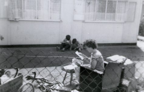 Woman and two boys in the garden of a prefab in Underhill Road, London SE22