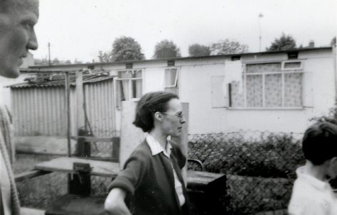 Man, woman and child outside the prefab in Underhill Road, London SE22