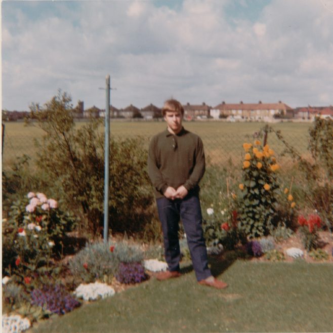 Richard in his prefab back garden overlooking the playing fields. Kedleston Gardens, Hainault