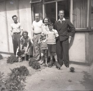 Catherine's cousins, her Nan, and her aunt and uncles outside their prefab in Carol Street, Camden Town. | Catherine Bazell