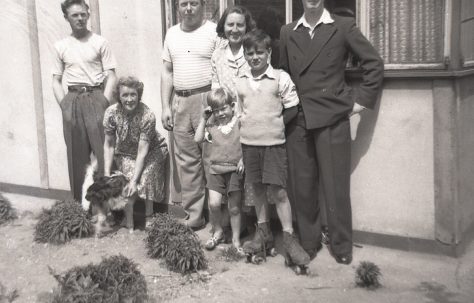 Catherine's cousins, her Nan, and her aunt and uncles outside their prefab in Carol Street, Camden Town.