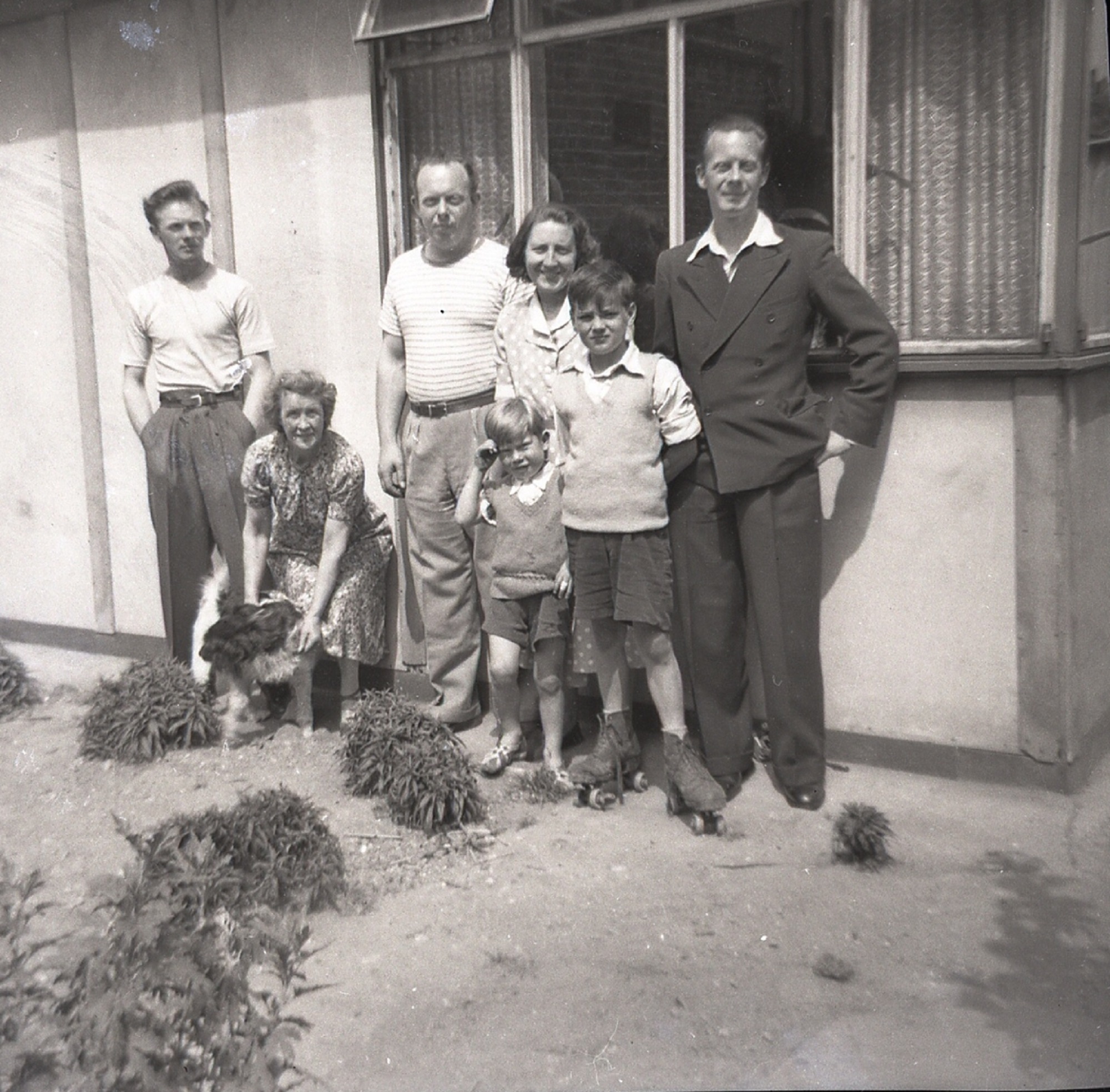 Catherine's cousins, her Nan, and her aunt and uncles outside their prefab in Carol Street, Camden Town.