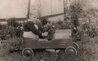 Boy racer. Ben in a toy car outside his prefab in Dartmouth Park Hill, London N19 Boy racer. Ben in a toy car outside his prefab in Dartmouth Park Hill, London N19