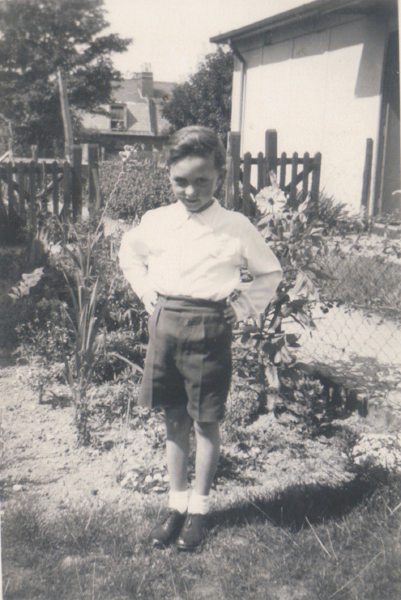 Terence standing by the flowerbed in his prefab garden, Dartmouth Park Hill, London N19