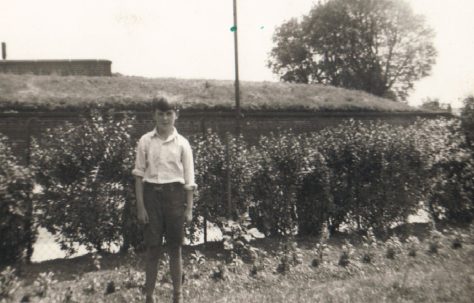 Terence's next door neighbour John standing by the hedge in his prefab garden, Dartmouth Park Hill, London NW5