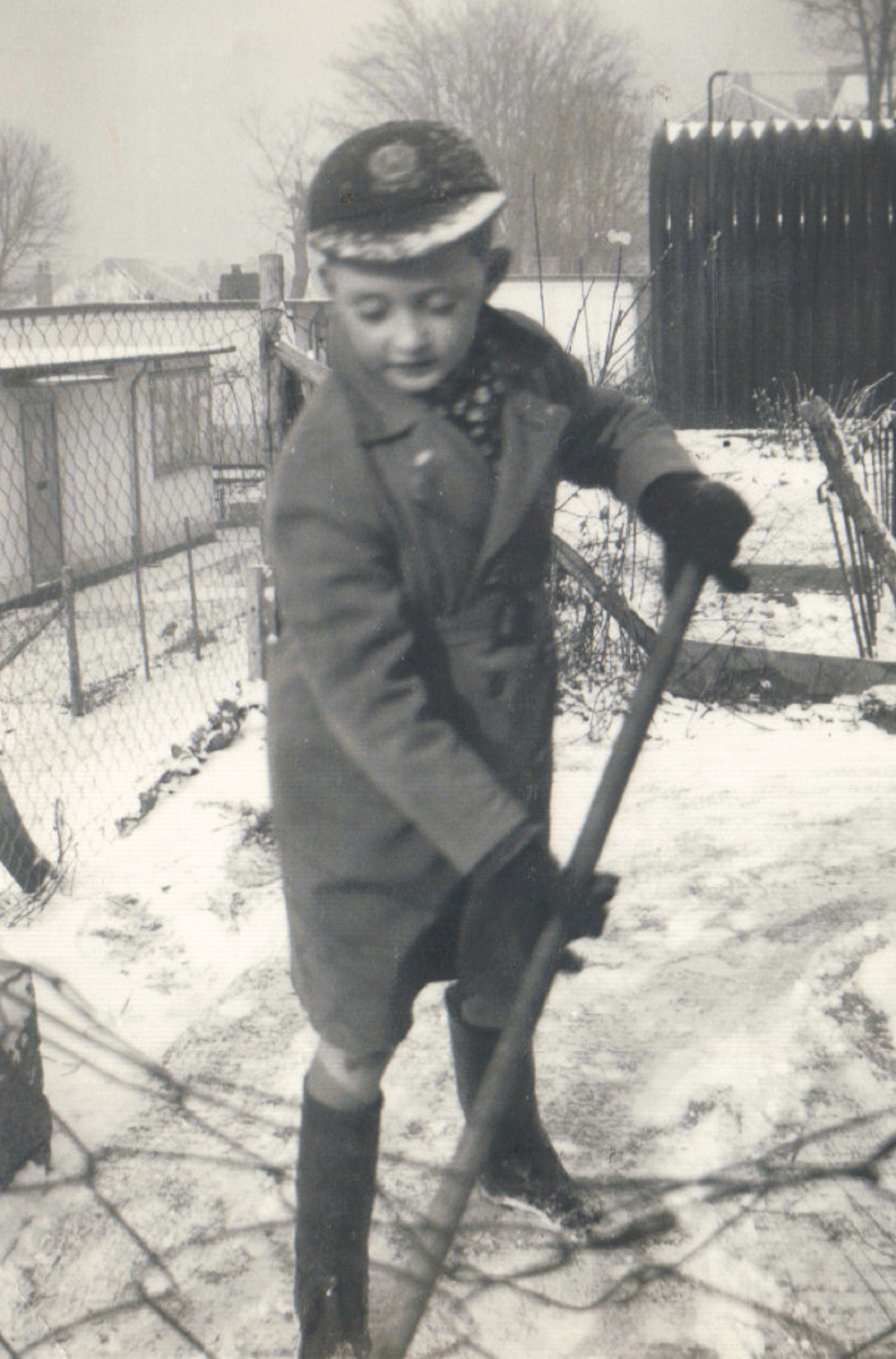 Terence shovelling snow outside his prefab in Dartmouth Park Hill, London N19