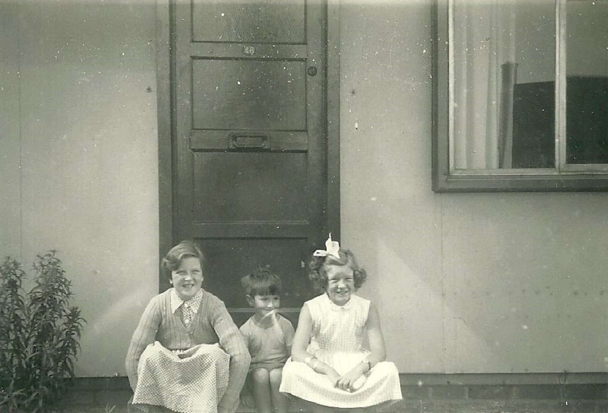 Mel, Peter and Hilary Ball  on the step of their prefab, 48 Abbots Gardens, Shrewsbury