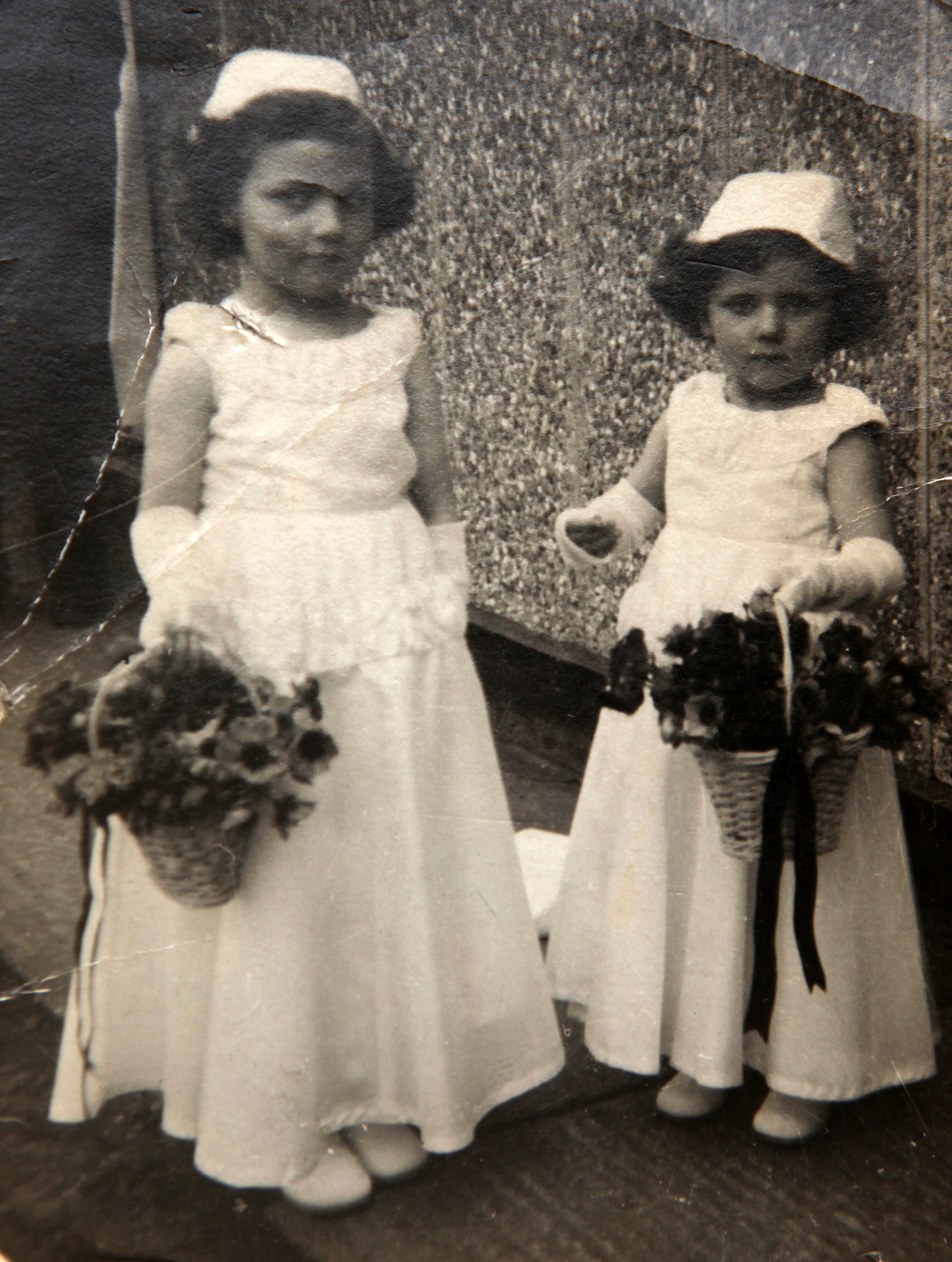 Two bridesmaids outside Tarran prefab. Bolsover