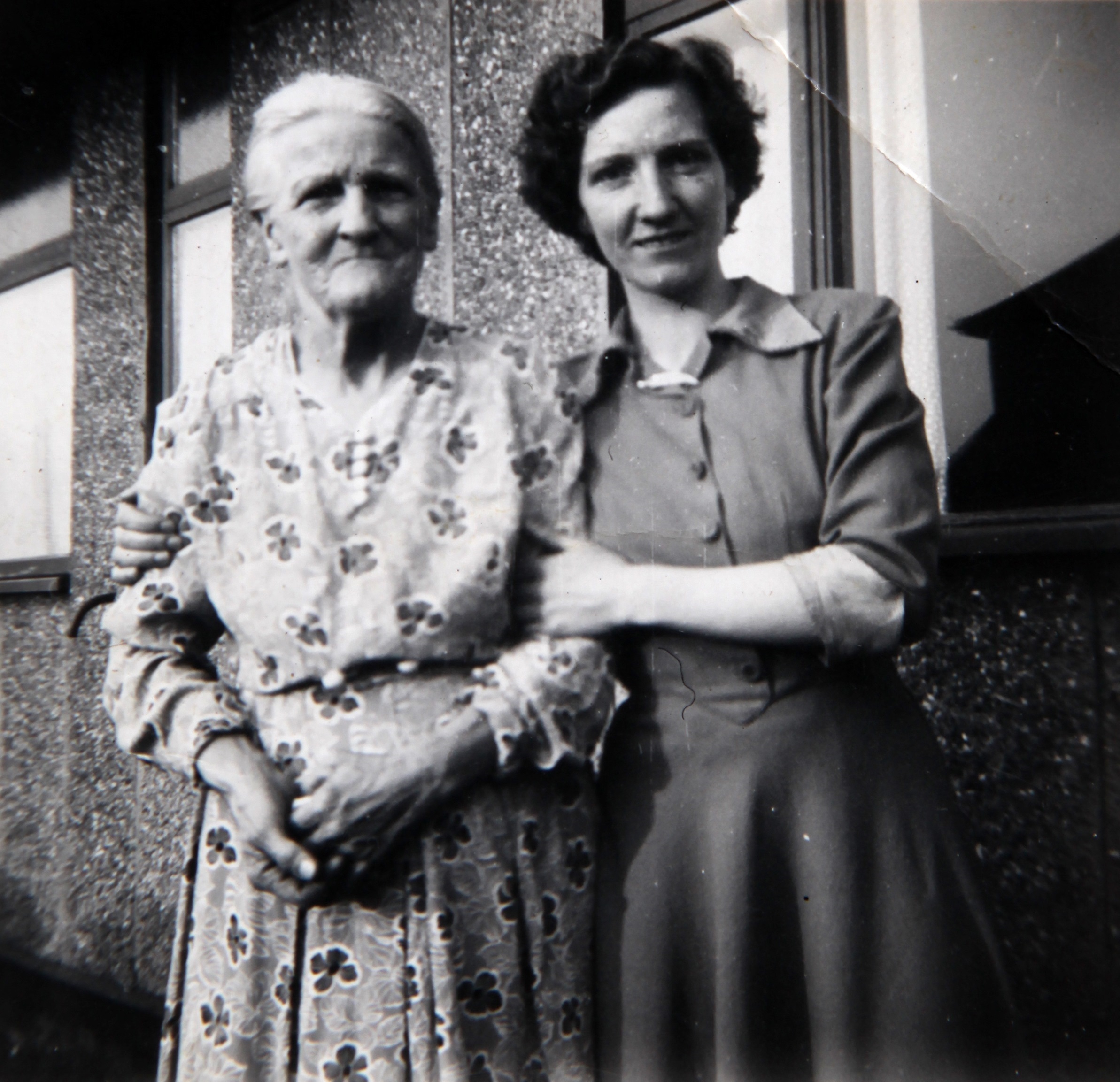 Mum with her grandmother outside Tarran prefab. Bolsover, Derbyshire