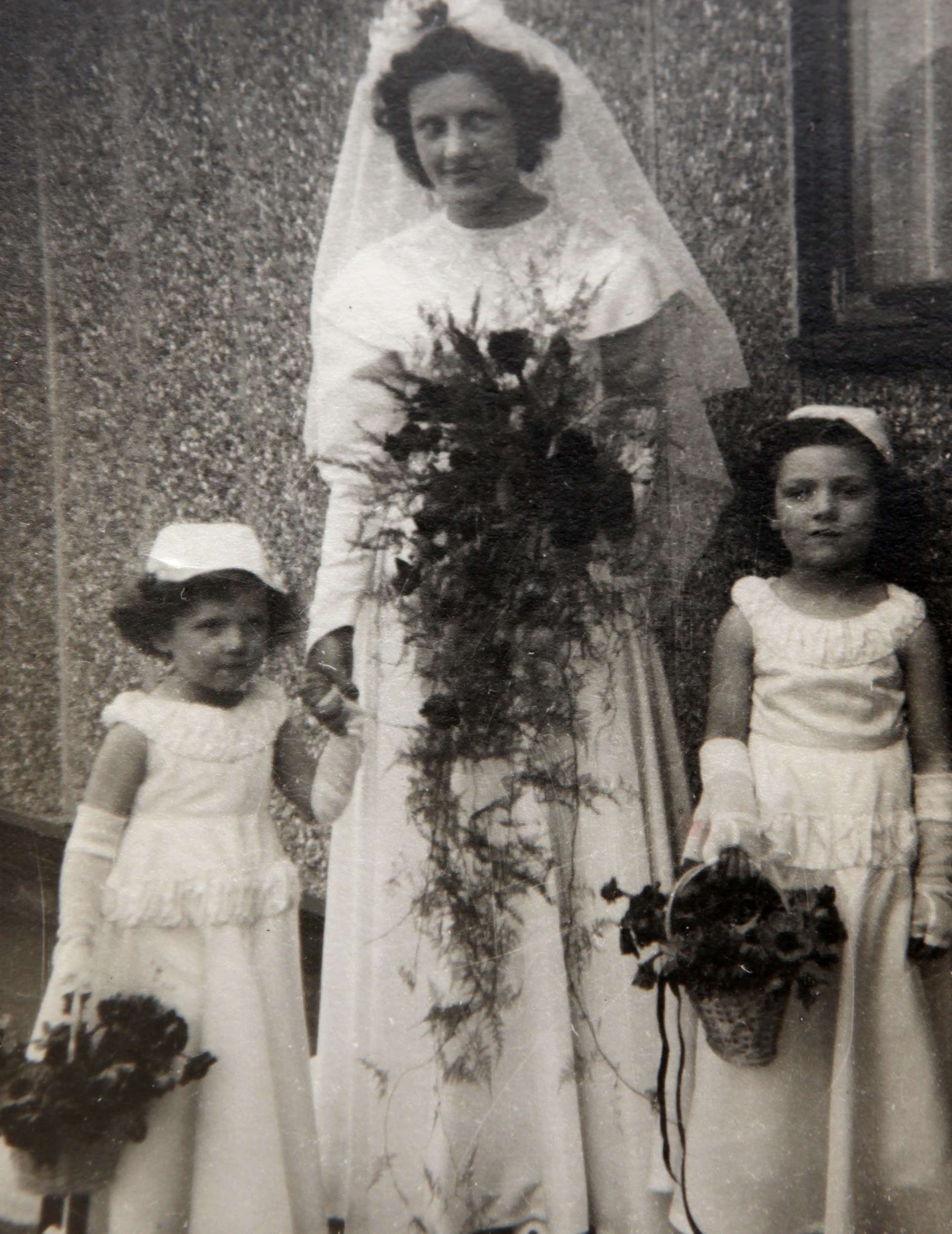 Bride and bridesmaids outside Tarran prefab. Bolsover