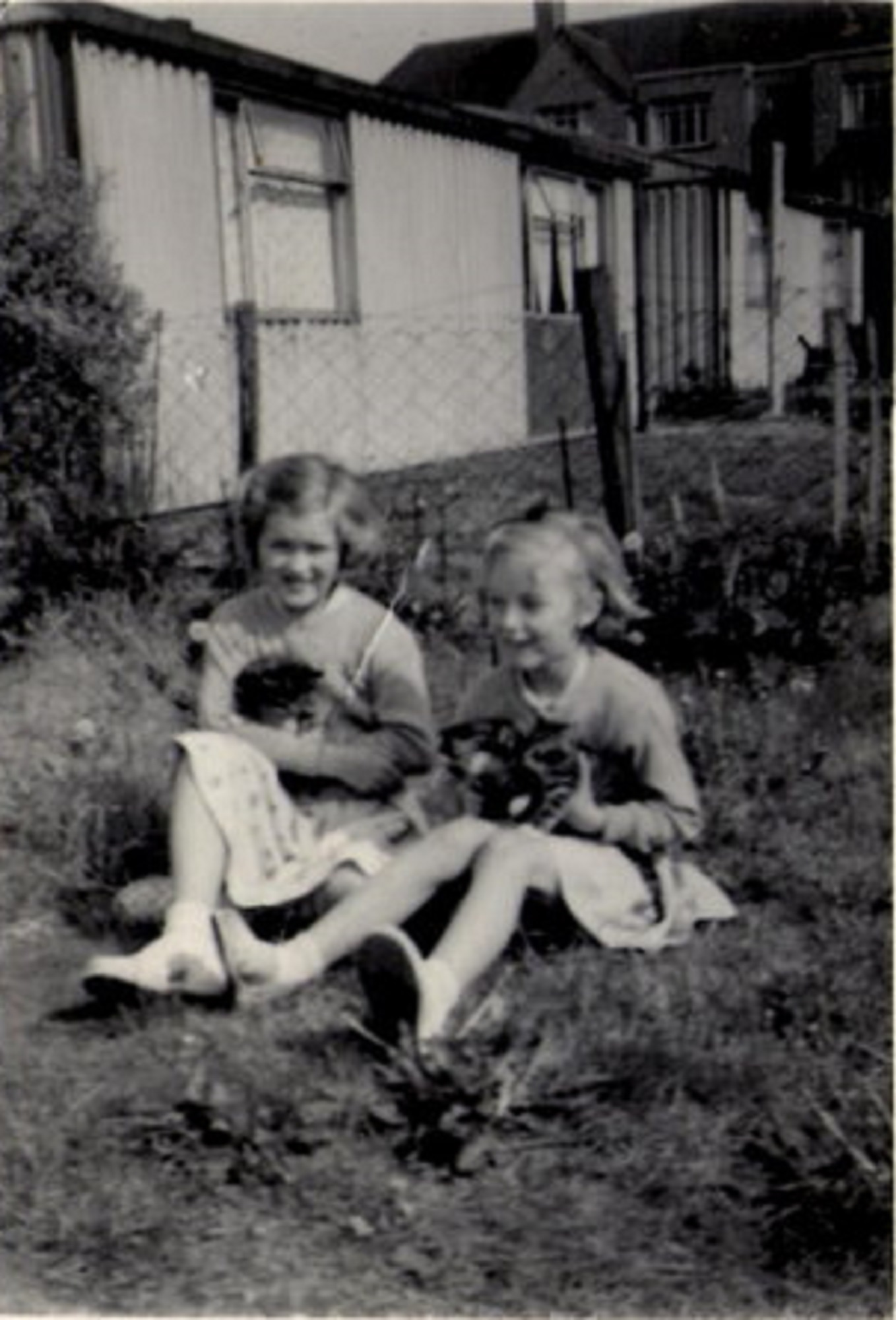 Jeannette Anderson and Brenda Anderson with kittens in the prefab garden. Hollyhedge bungalows, Blackheath, London SE3