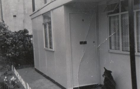 The front porch showing large living room window and hallway window, and Rinty. Tooke Street, London E14