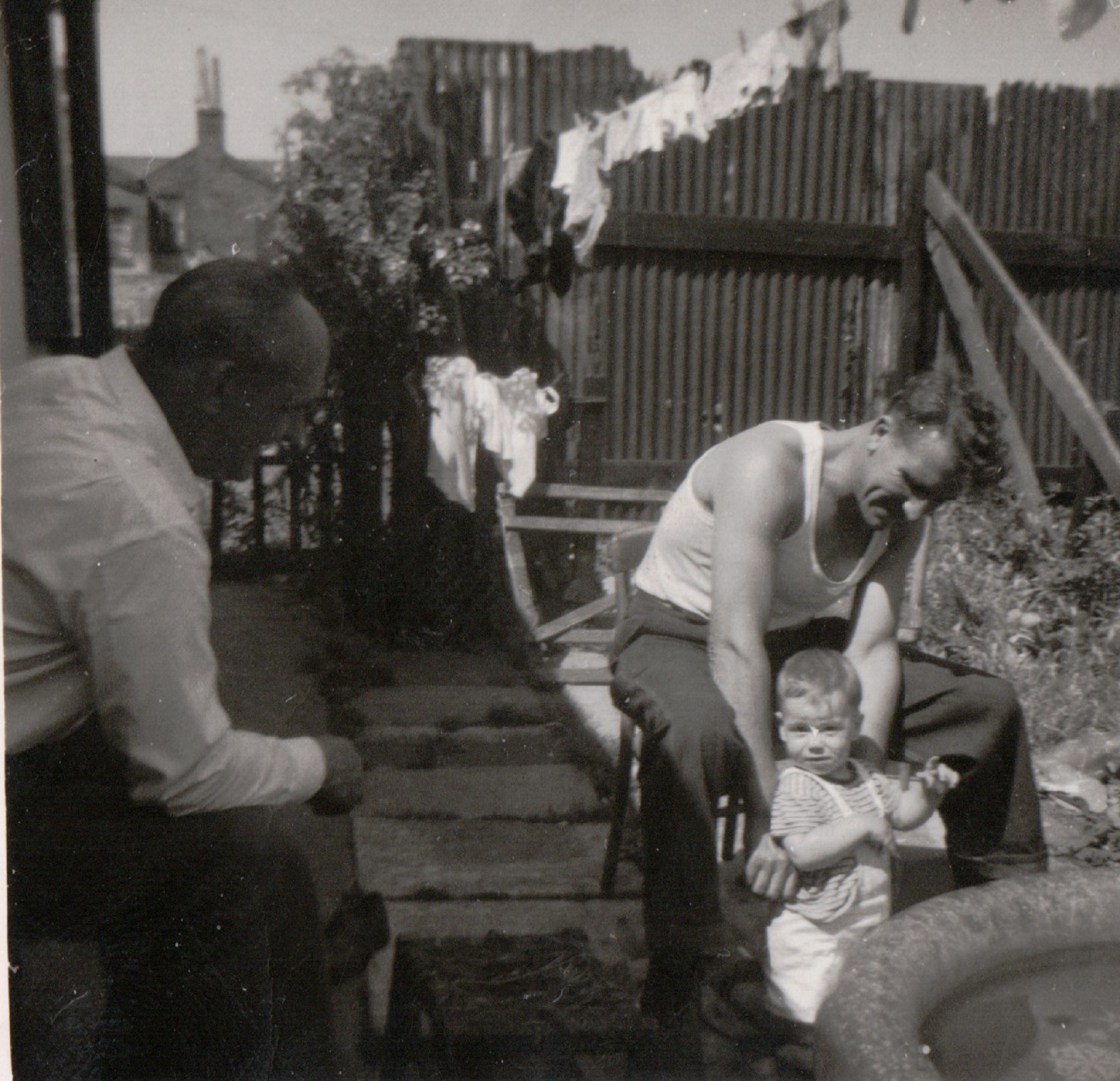 East side of our prefab, Andy, Uncle Dennis and my brother Tony about 1960. Tooke Street, London E14