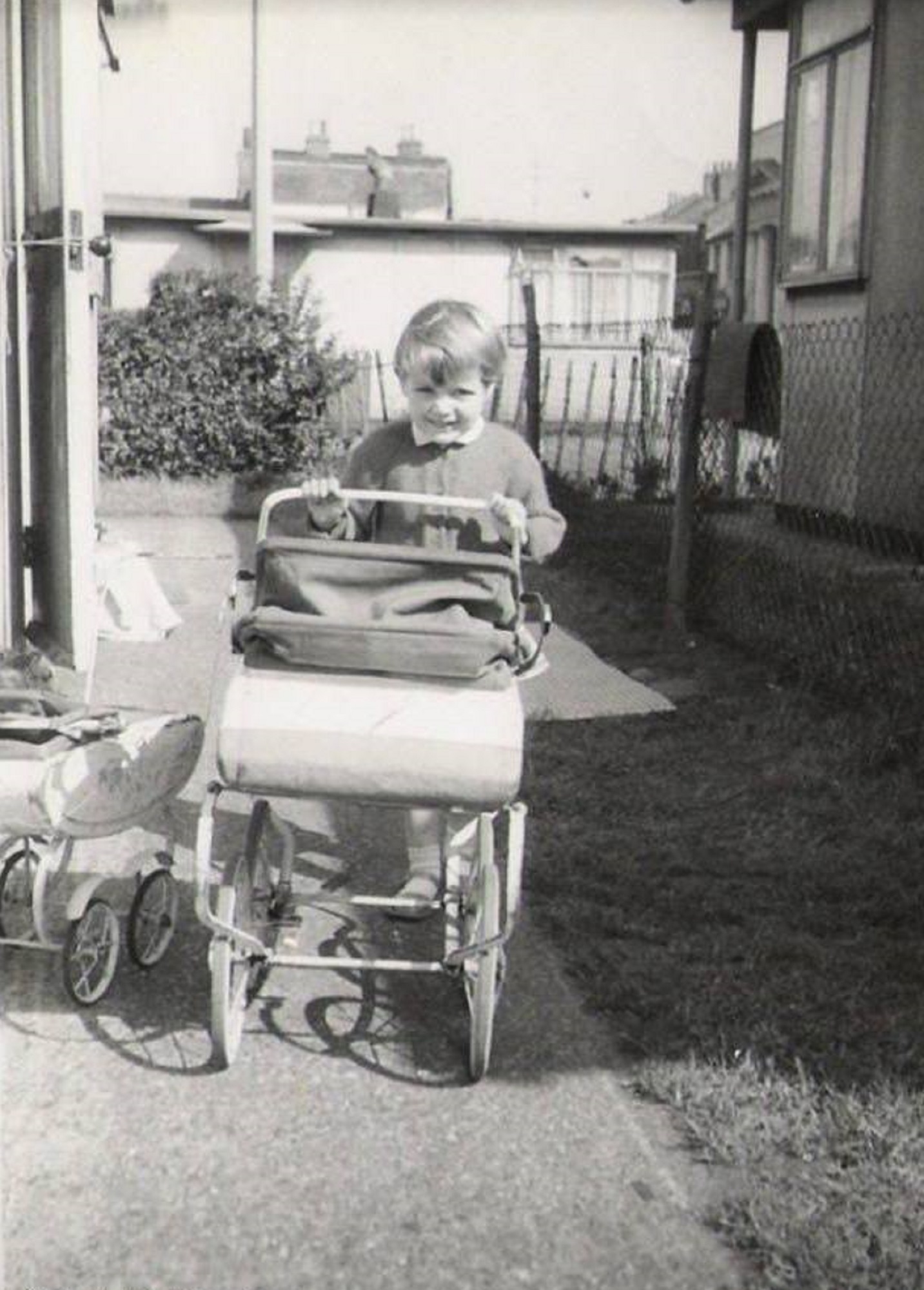 With her pram outside the prefab, No.5 Holmbrook street, off of Brooksbys Walk, London E9